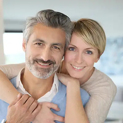  A couple smiling at camera.