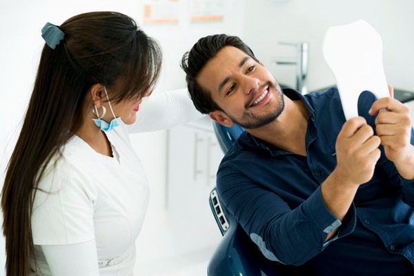 Patient looking at their teeth with their dentist